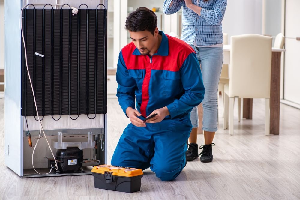A man and woman pose in front of an air conditioner, highlighting commercial appliance repair services in Everett, WA.