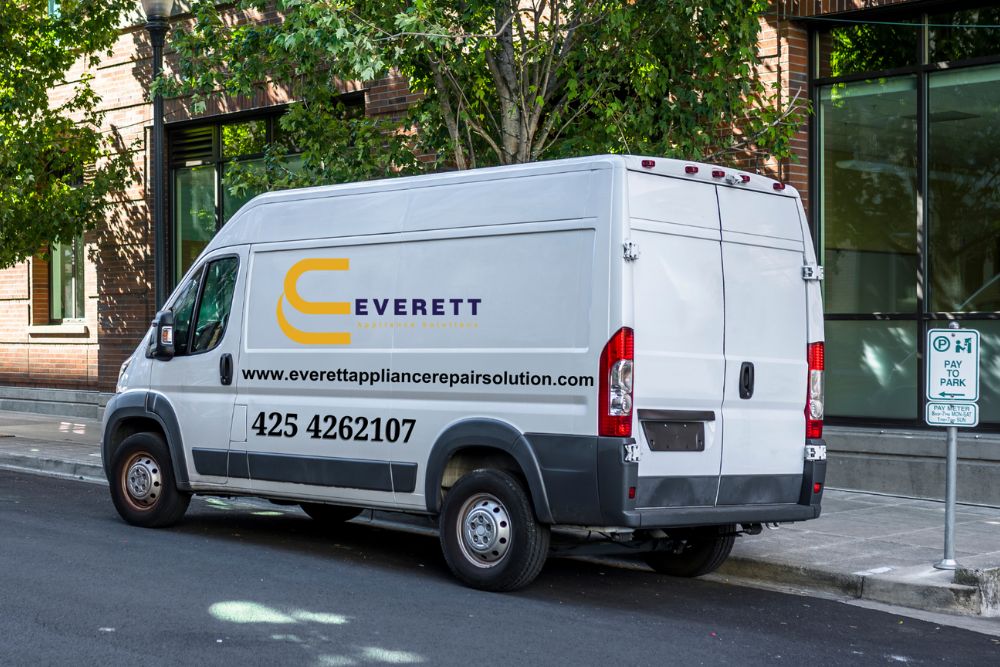 A white van parked along the road, associated with appliances repair services in Everett, WA.